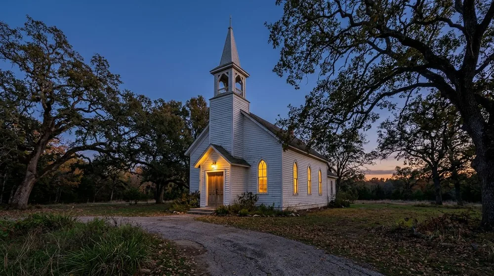 Lanternway Church at dusk with its windows glowing